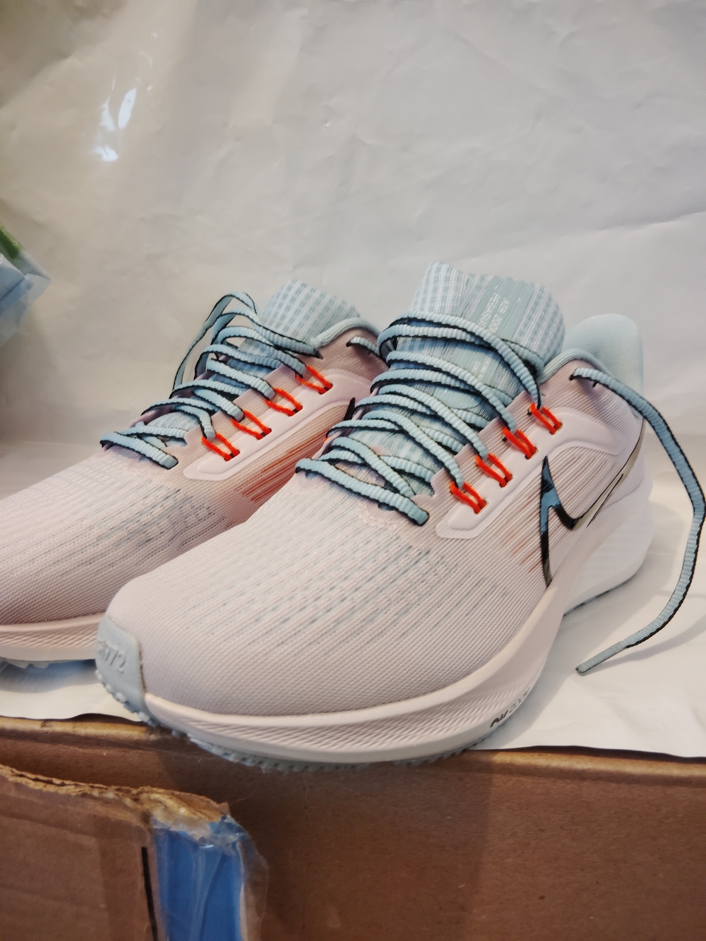 Nike Women's Light Pink & Light Blue Running Shoes with Orange Accents